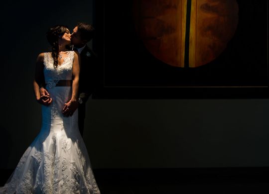 Dramatic Bride and groom kissing portrait