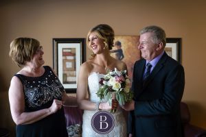 Bride with parents getting ready for wedding