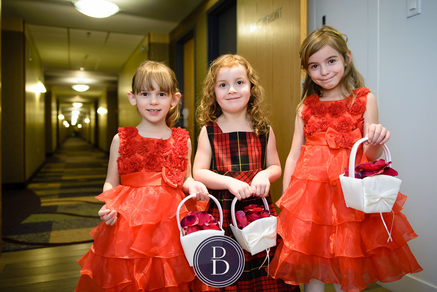 wedding flower girls in red dresses with baskets