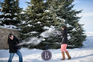 winter photo engagement session snowball fight at the Forks