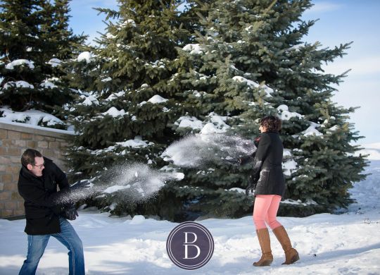 winter photo engagement session snowball fight at the Forks