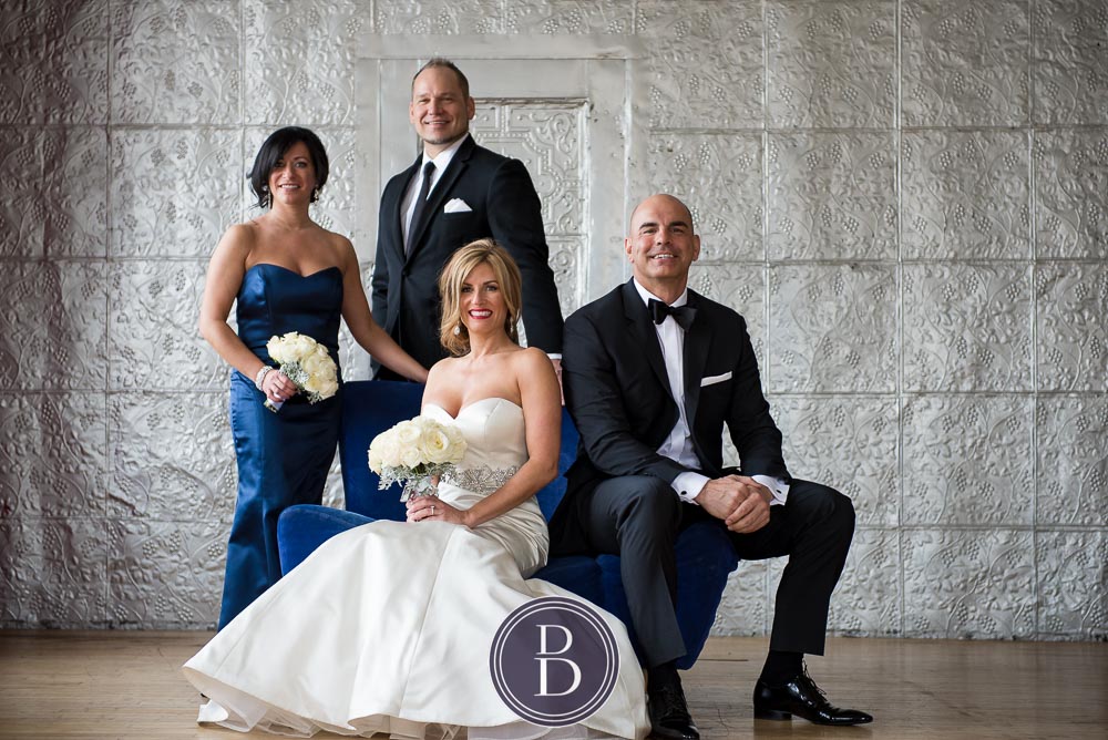 An elegant blue winter wedding in Winnipeg, Manitoba. Beautiful portrait at a studio of couple with bridal party