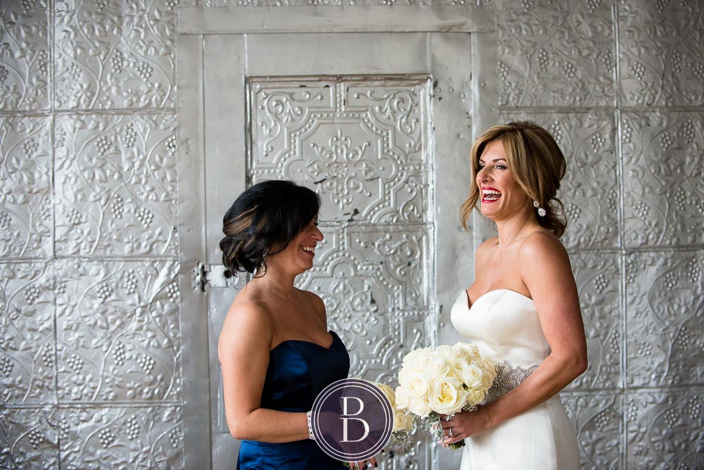 An elegant blue winter wedding in Winnipeg, Manitoba. Bride with maid of honour all smiling and having a good time
