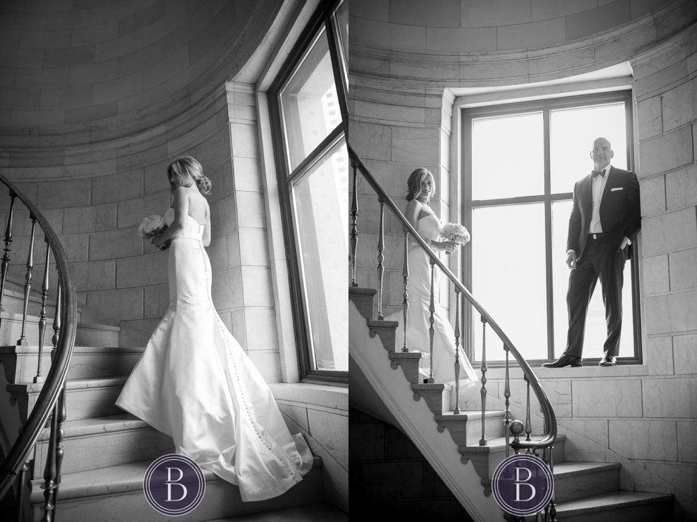 elegant blue wedding photo of bride and groom on spiral staircase by a large window in Winnipeg