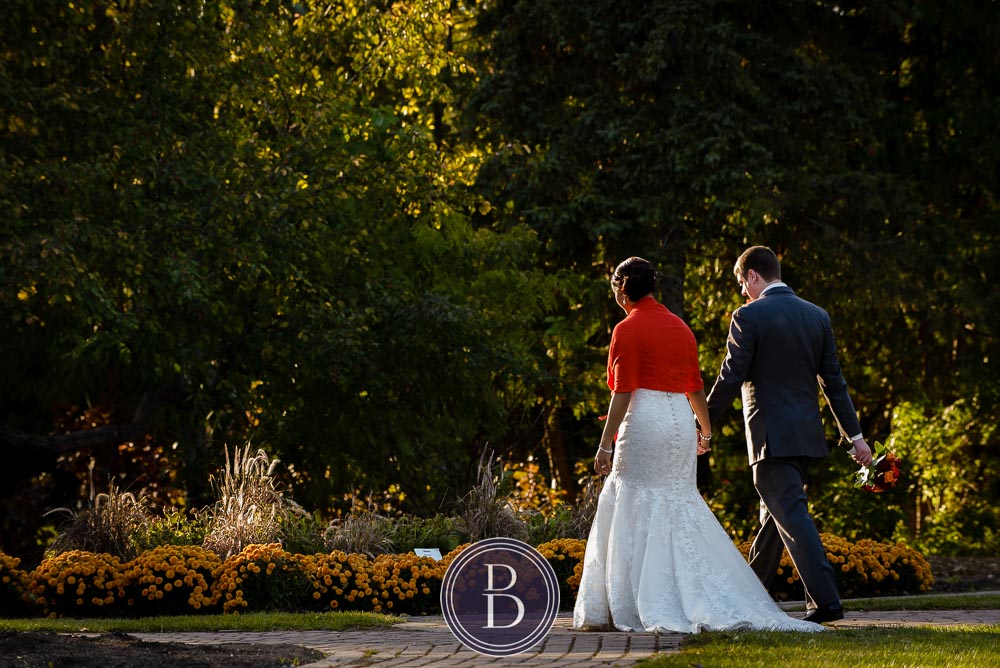 Winnipeg wedding photos portrait bride and groom holding hands walking at Assiniboine Park