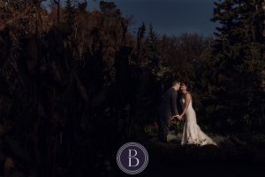 Winnipeg wedding photos portrait bride and groom going to kiss at Assiniboine Park