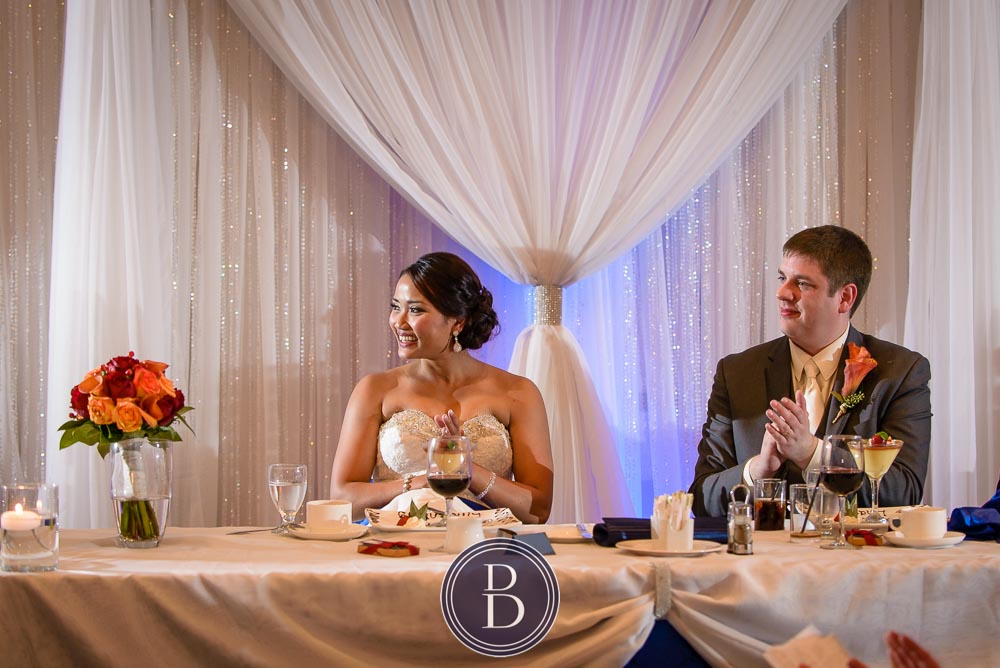 Winnipeg wedding photos bride and groom during speeches Victoria Inn Hotel head table