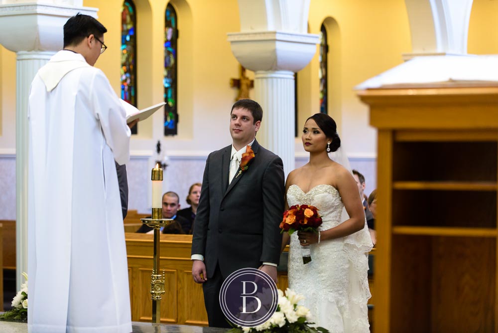 Winnipeg wedding photos St Mary's Cathedral bride and groom holding hands during ceremony