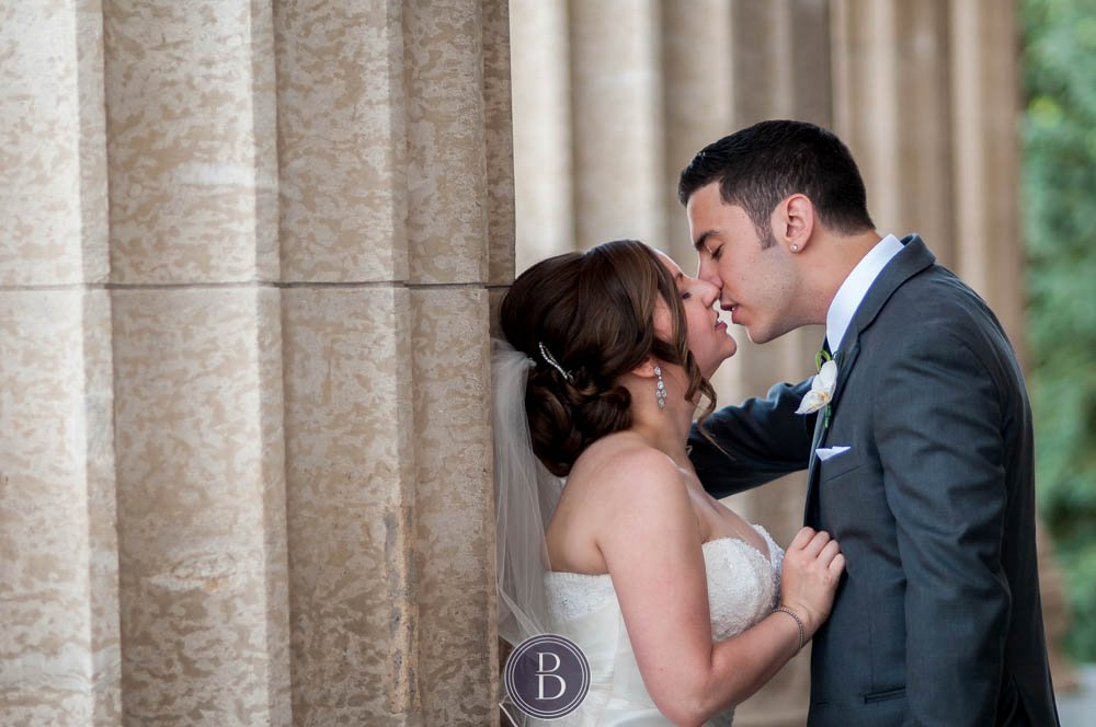 Bride and groom getting closer for a kiss during formal photos manitoba legislative building