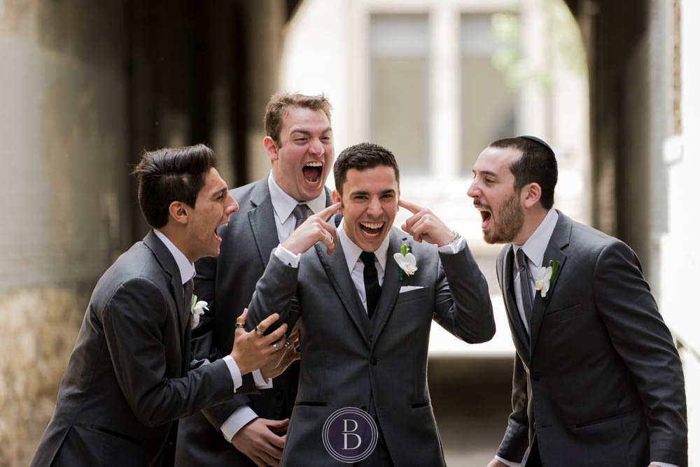 Groom with boys goofing off during portrait session Winnipeg exchange