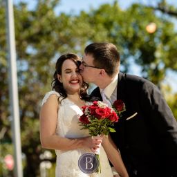 Winnipeg Wedding Photos Manitoba groom kissing bride on cheek as she smiles