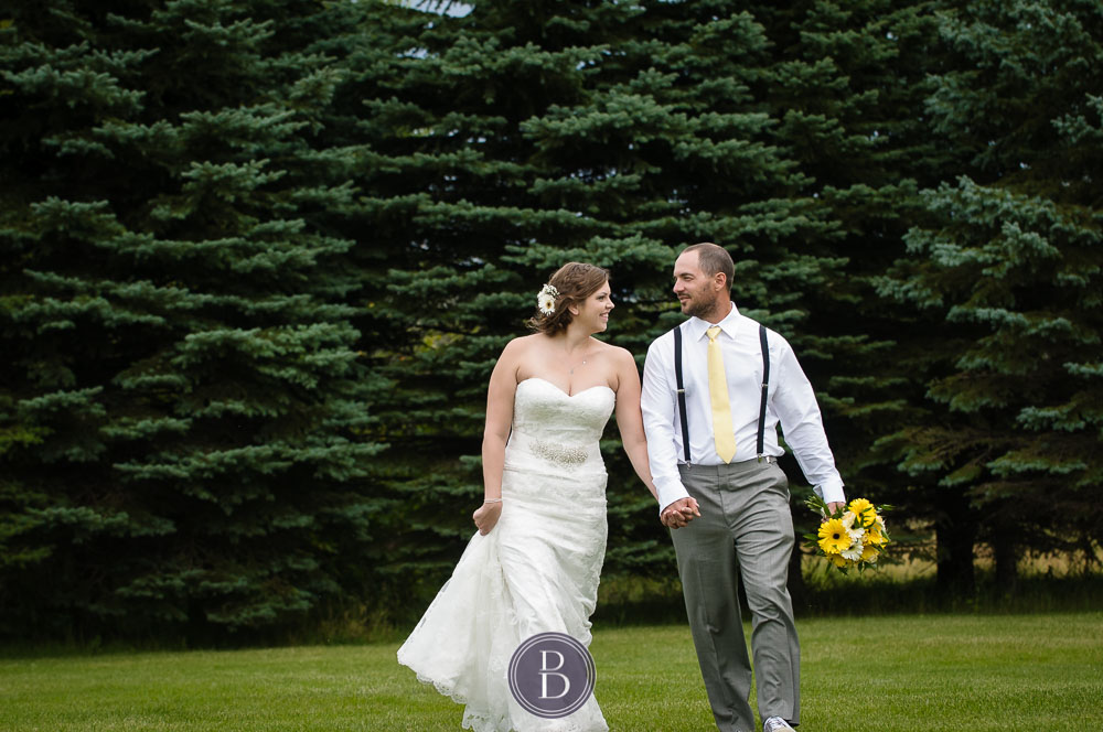 bride and groom portrait walking and holding hands in love