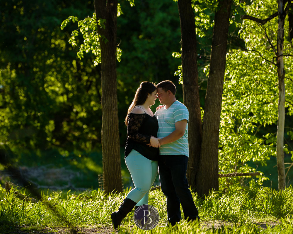 engagement photos newly engaged couple in love holding each other sunset in trees