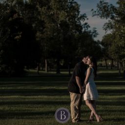 kiss on the cheek under the sunset engagement photography