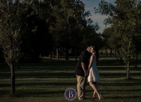 kiss on the cheek under the sunset engagement photography