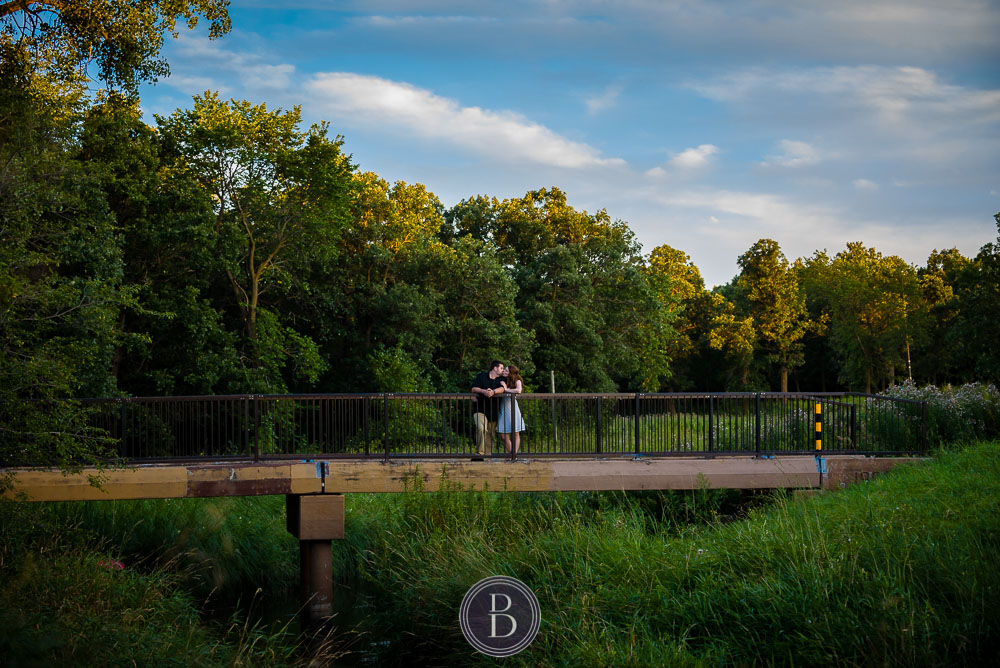 Engaged couple on bridge at Bunn's Creek park