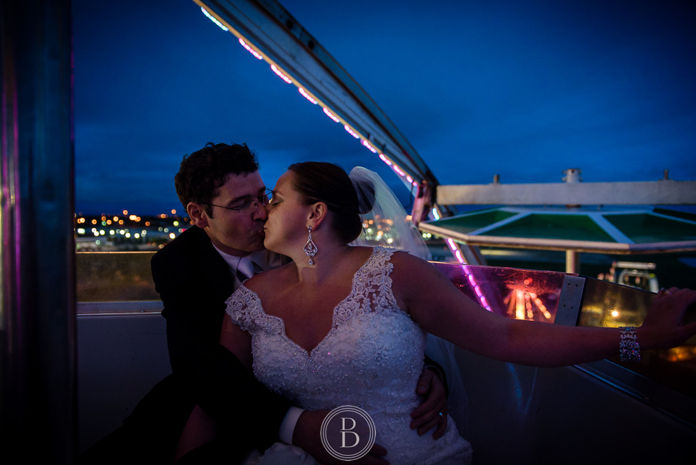 Winnipeg wedding images Red River Ex bride and groom kiss ferris wheel at night