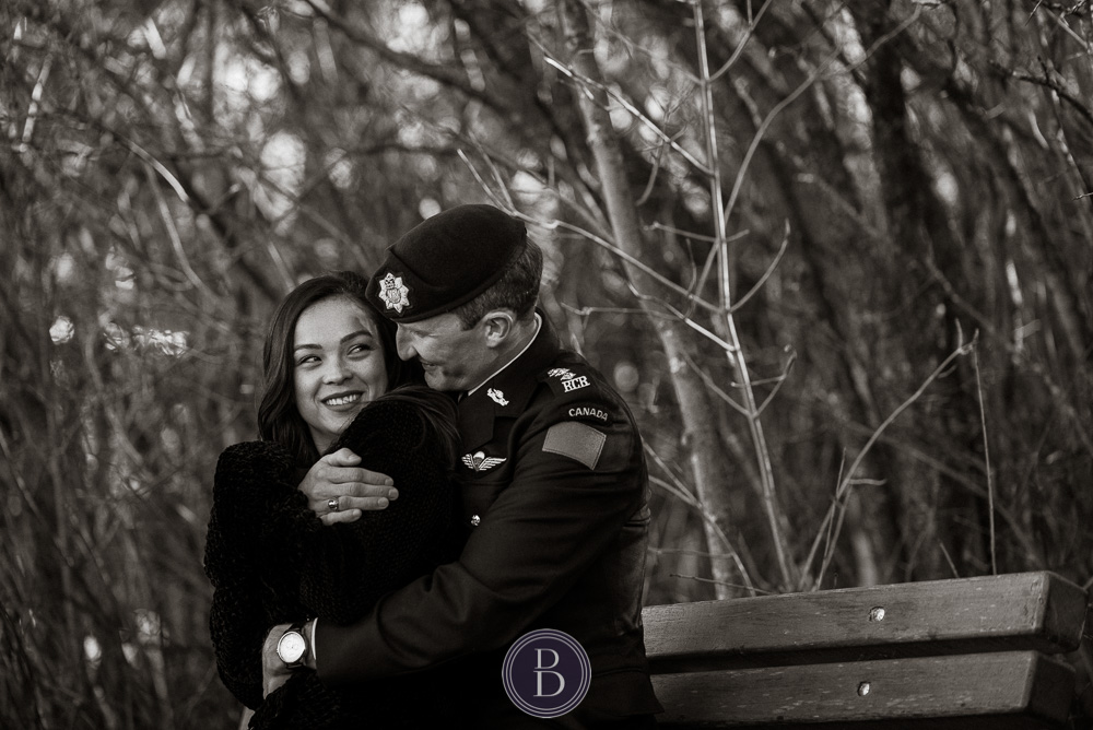 Engaged couple on bench Assiniboine park in love and smiles