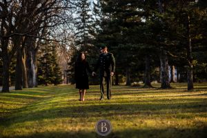 Engaged couple walking sunset Assiniboine park