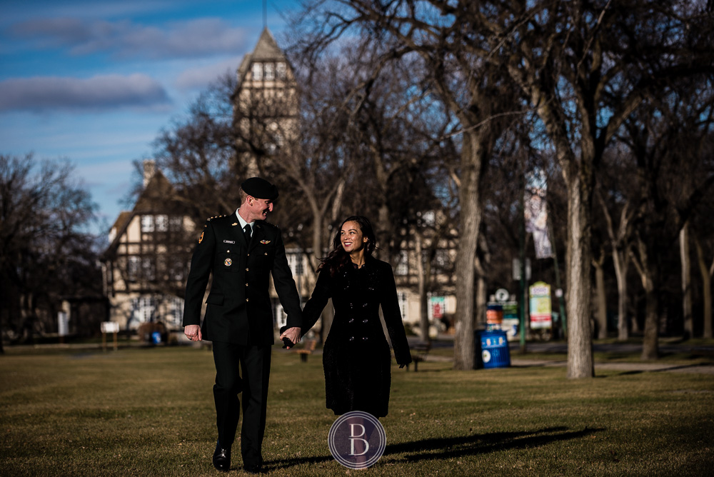 Engaged couple walking at park smiling in love