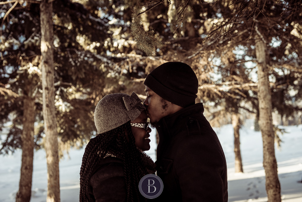 Winnipeg winter engagement photo session kiss on forehead The Forks