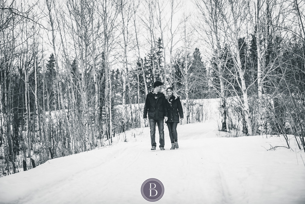 Winter engagement photos couple smiling and walking outdoors