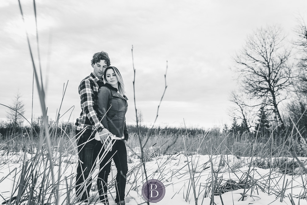 Winter engagement photos engaged couple field snow