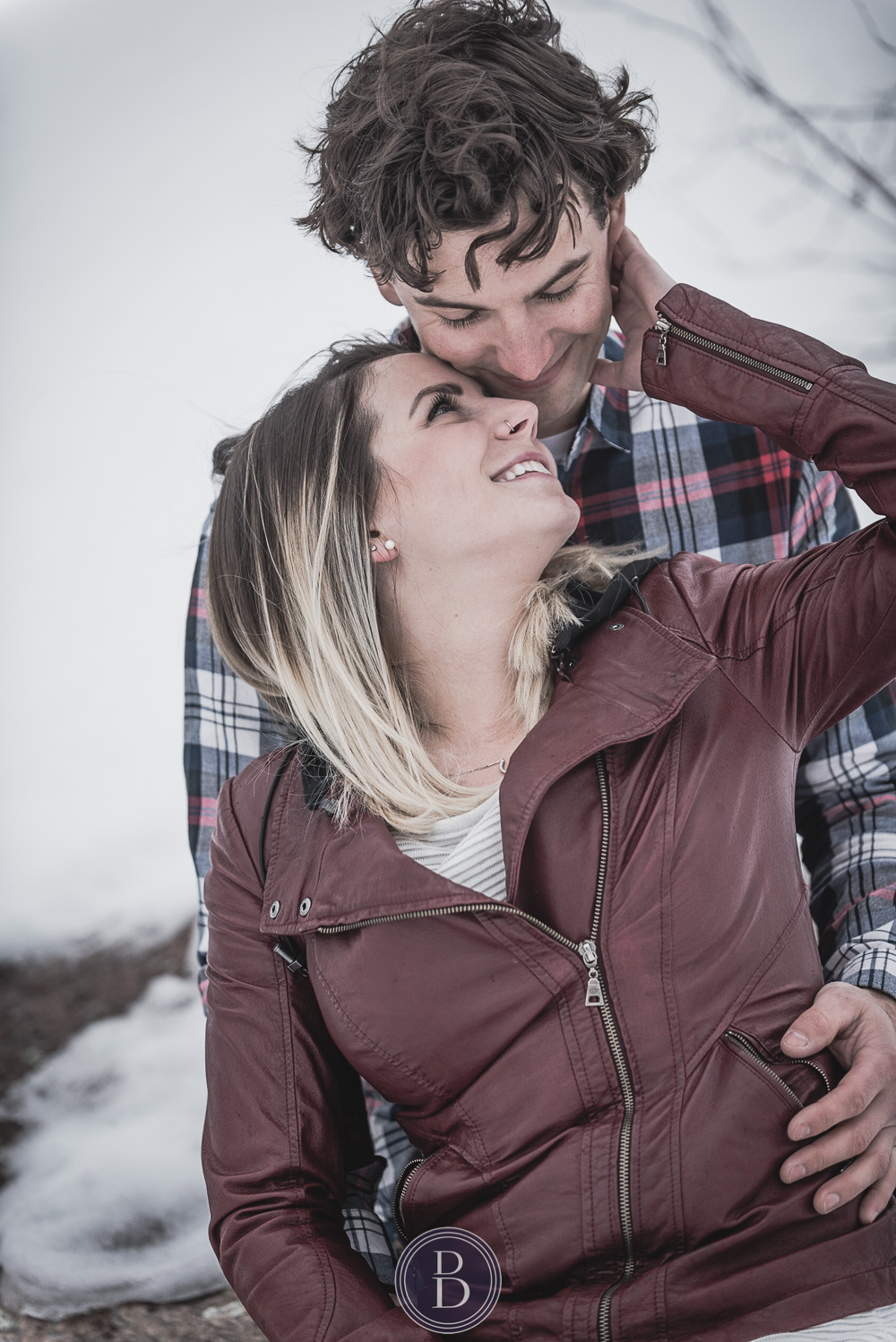 Winter engagement photos couple looking into each other eyes