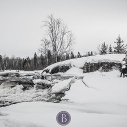 Winter engagement photos Pinawa Dam couple in snow kissing