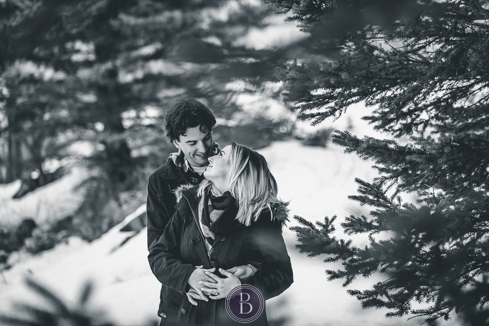 Winter engagement photos couple in forrest in love