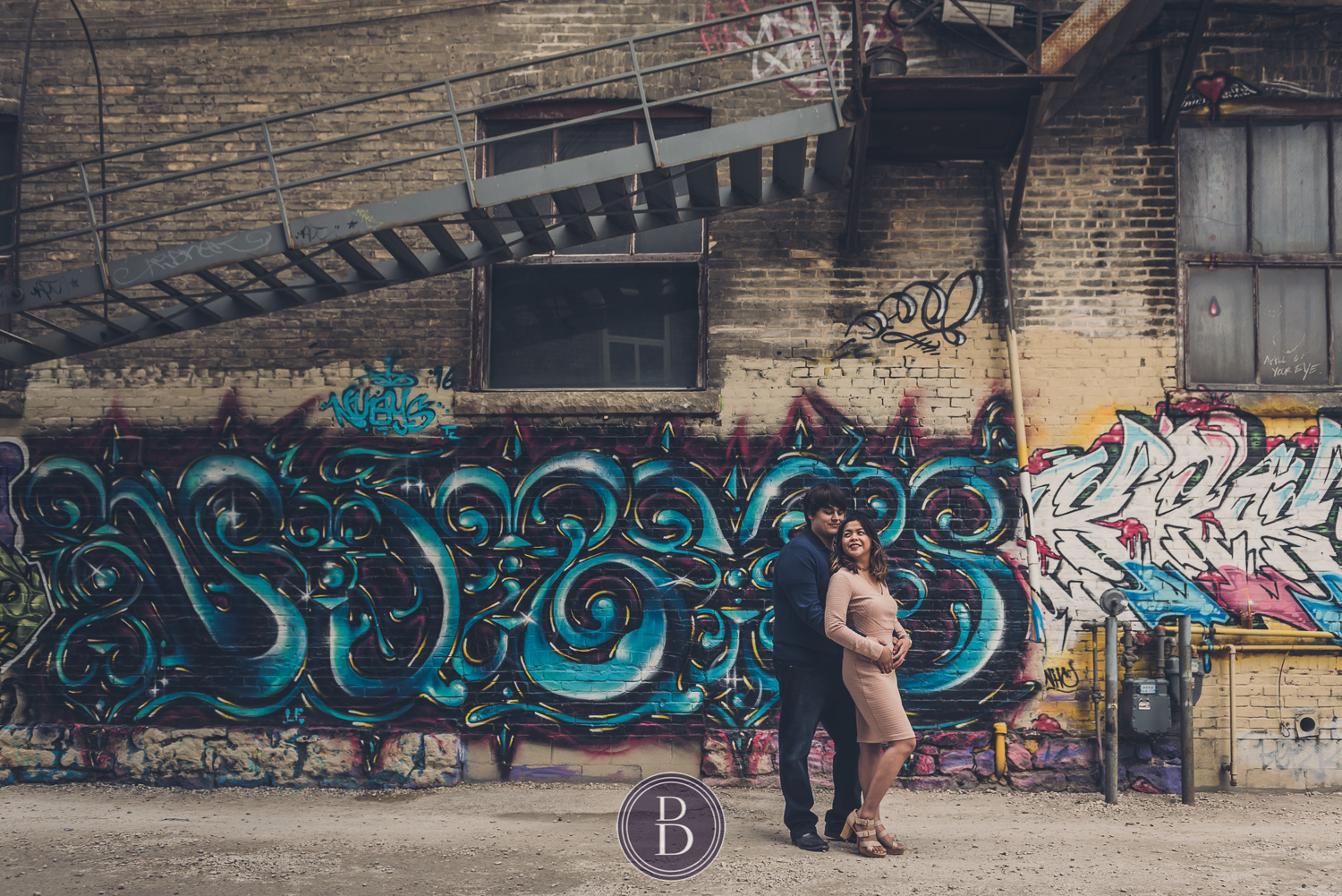 engaged couple by exchange district graffiti walls in love