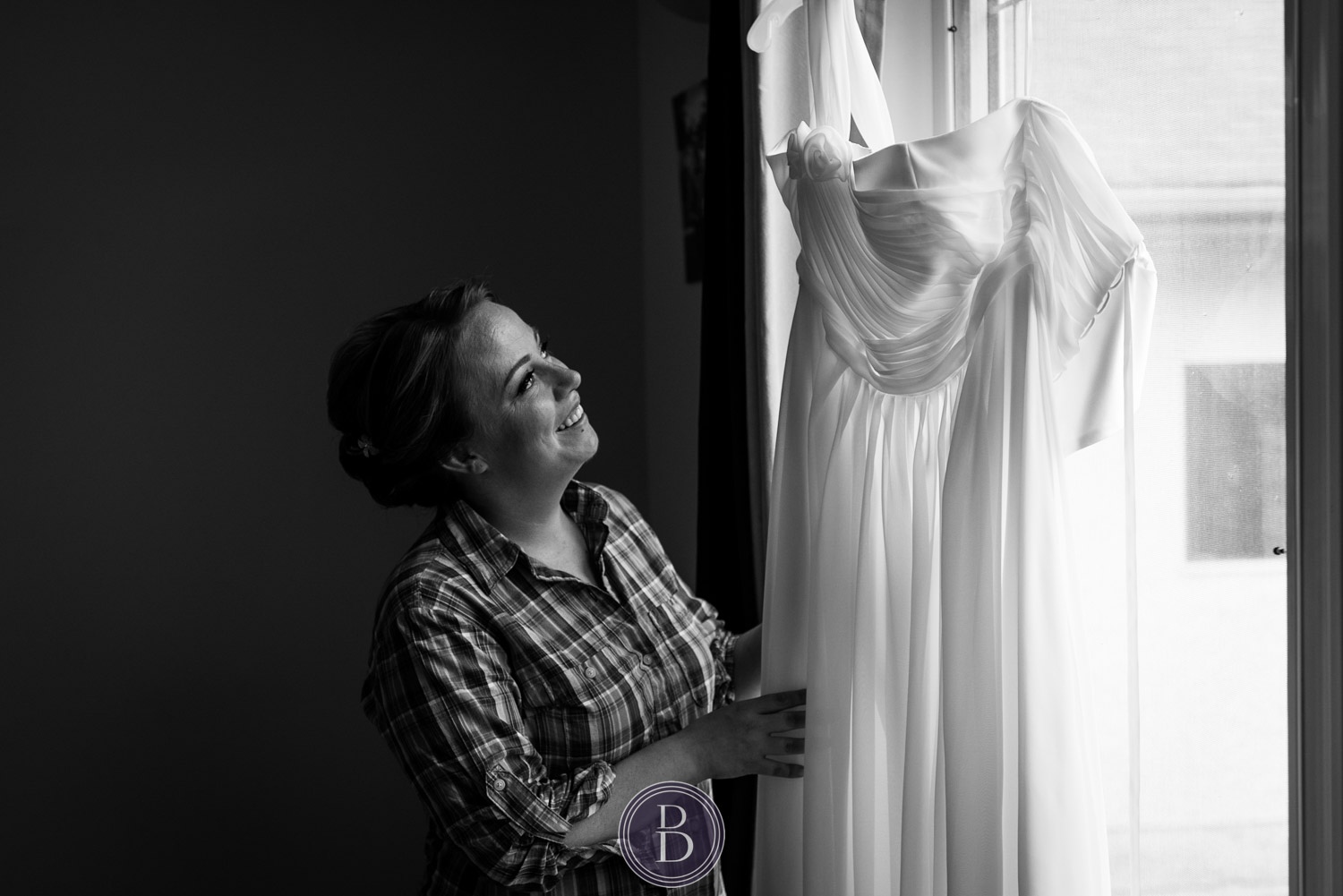Beausejour Manitoba Wedding bride getting ready looking at dress