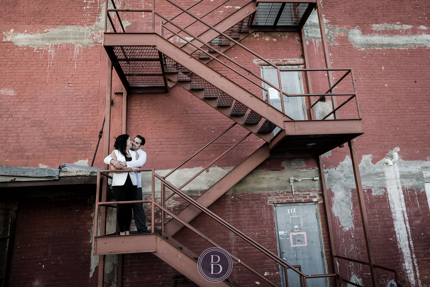 Romantic Engagement Session exchange couple on staircase