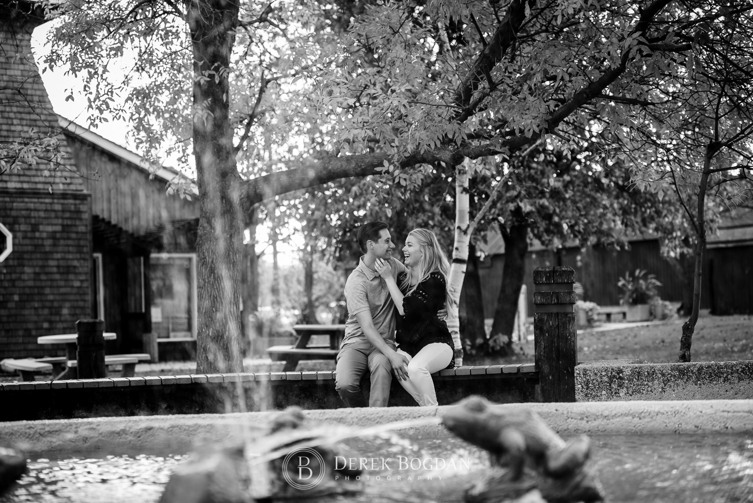 Gimli beach engagement photo session couple laughing by fountain