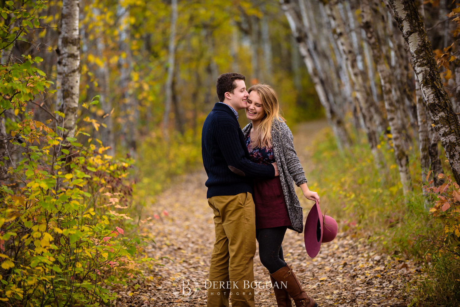 assiniboine forest fall engagement session couple in love smiles bride to be with a hat portrait