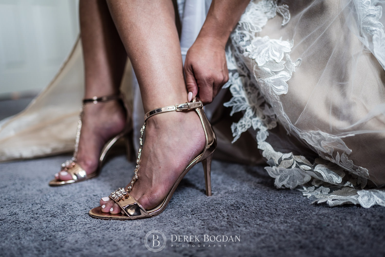 bride putting on bridal shoes getting ready for her wedding