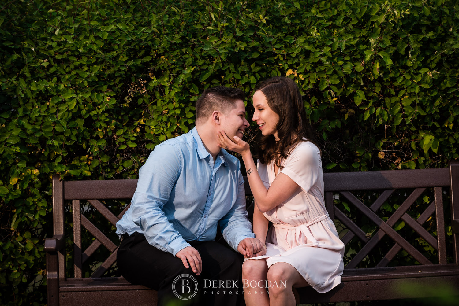 Evening engagement couple sitting on bench