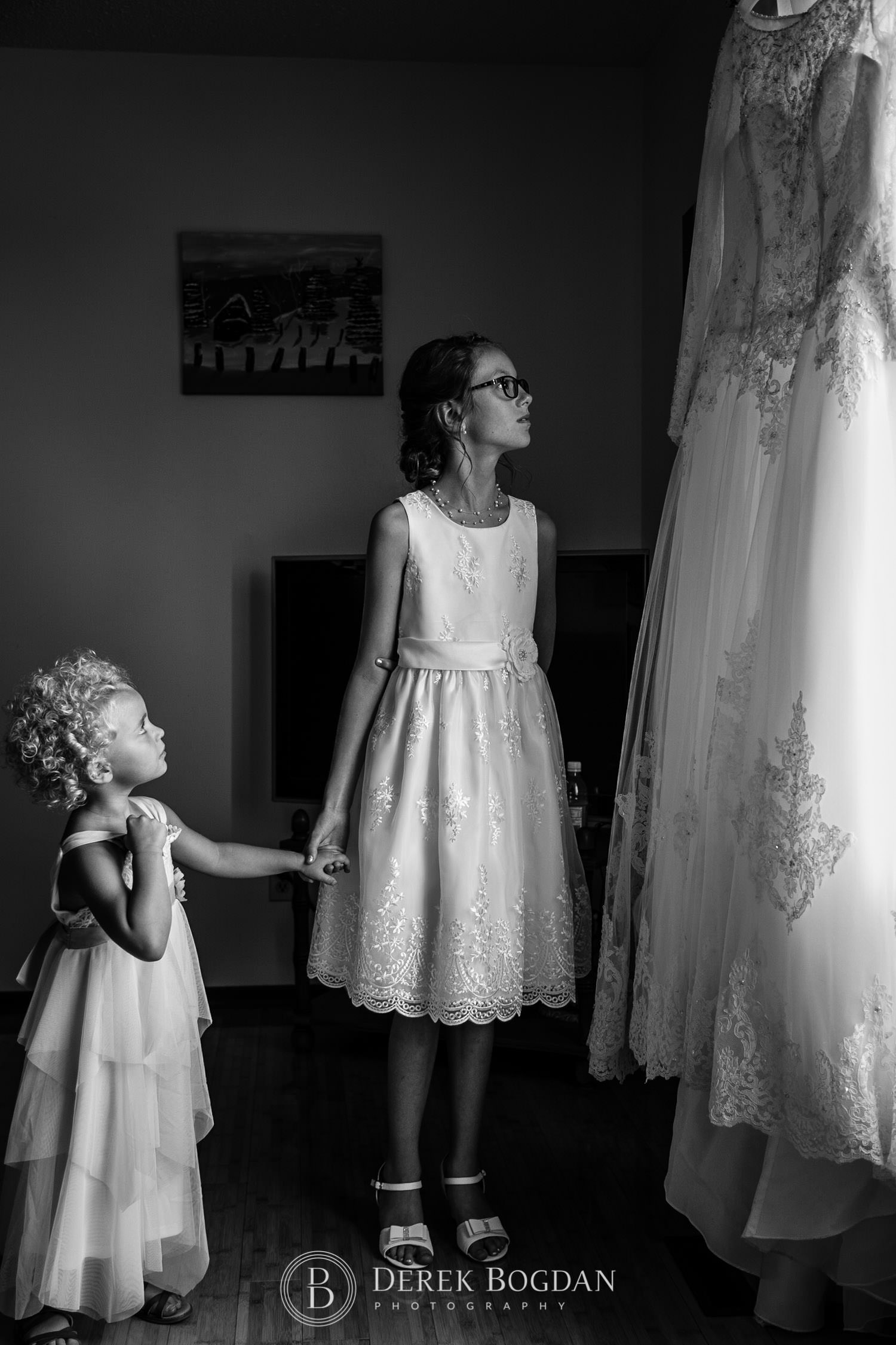 girls looking at beautiful wedding gown