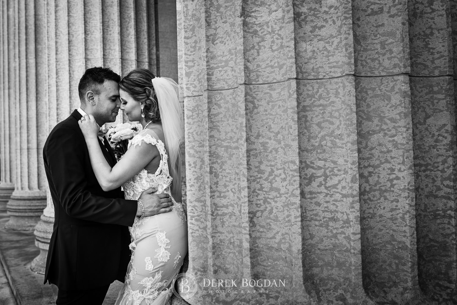 Couple in love by pillars wedding Manitoba Legislative