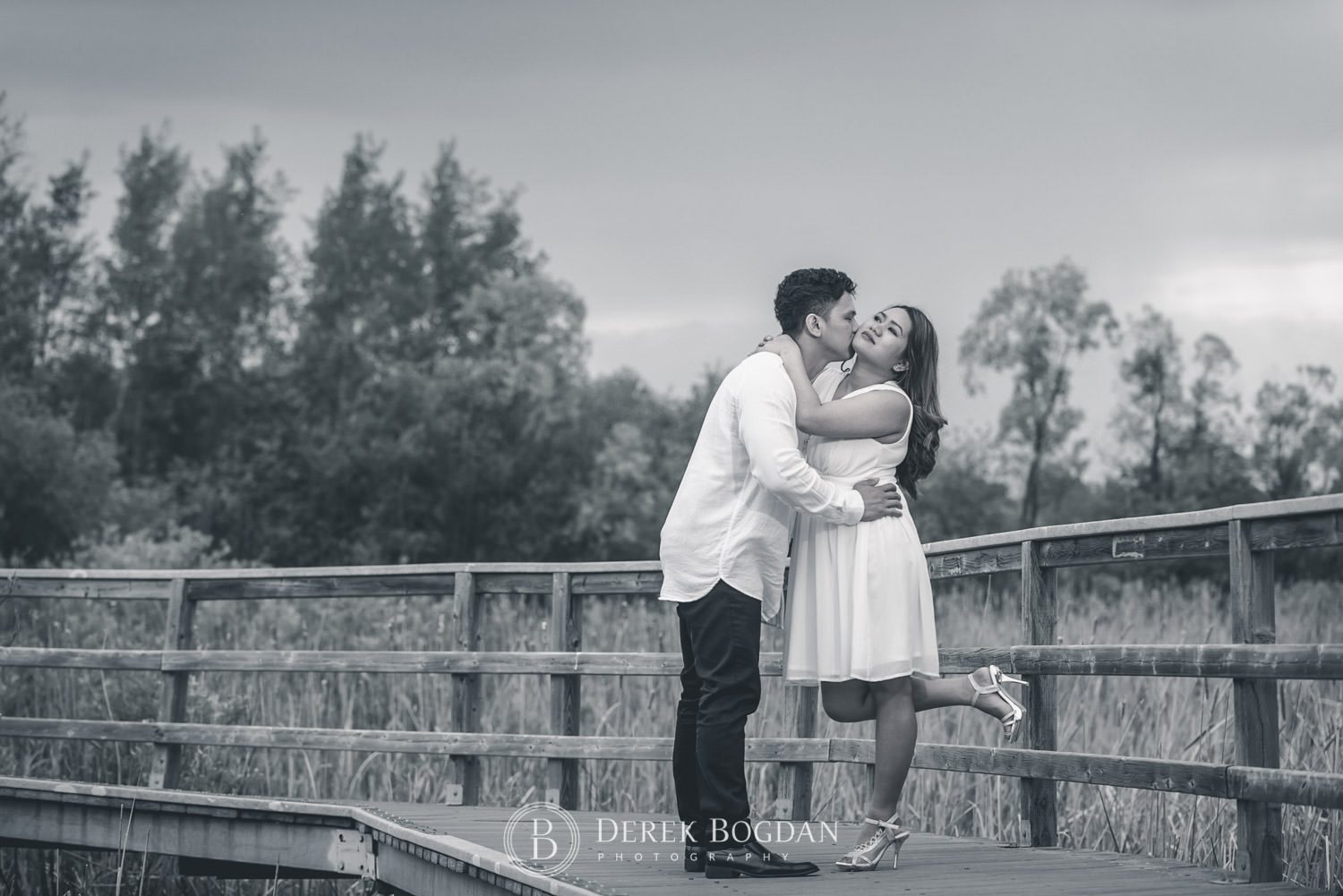 Winnipeg engagement photos at Assiniboine forest engaged couple in love taking a walk and a kiss outdoor