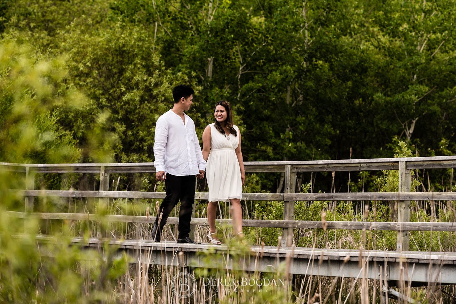 Winnipeg engagement photos at Assiniboine forest engaged couple in love taking a walk
