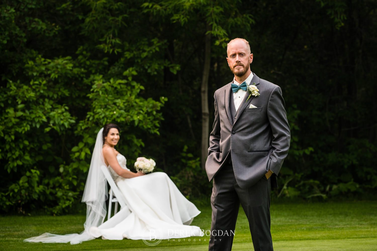 groom and bride on chair outdoor portrait on golf green Bel Acres Golf wedding Manitoba