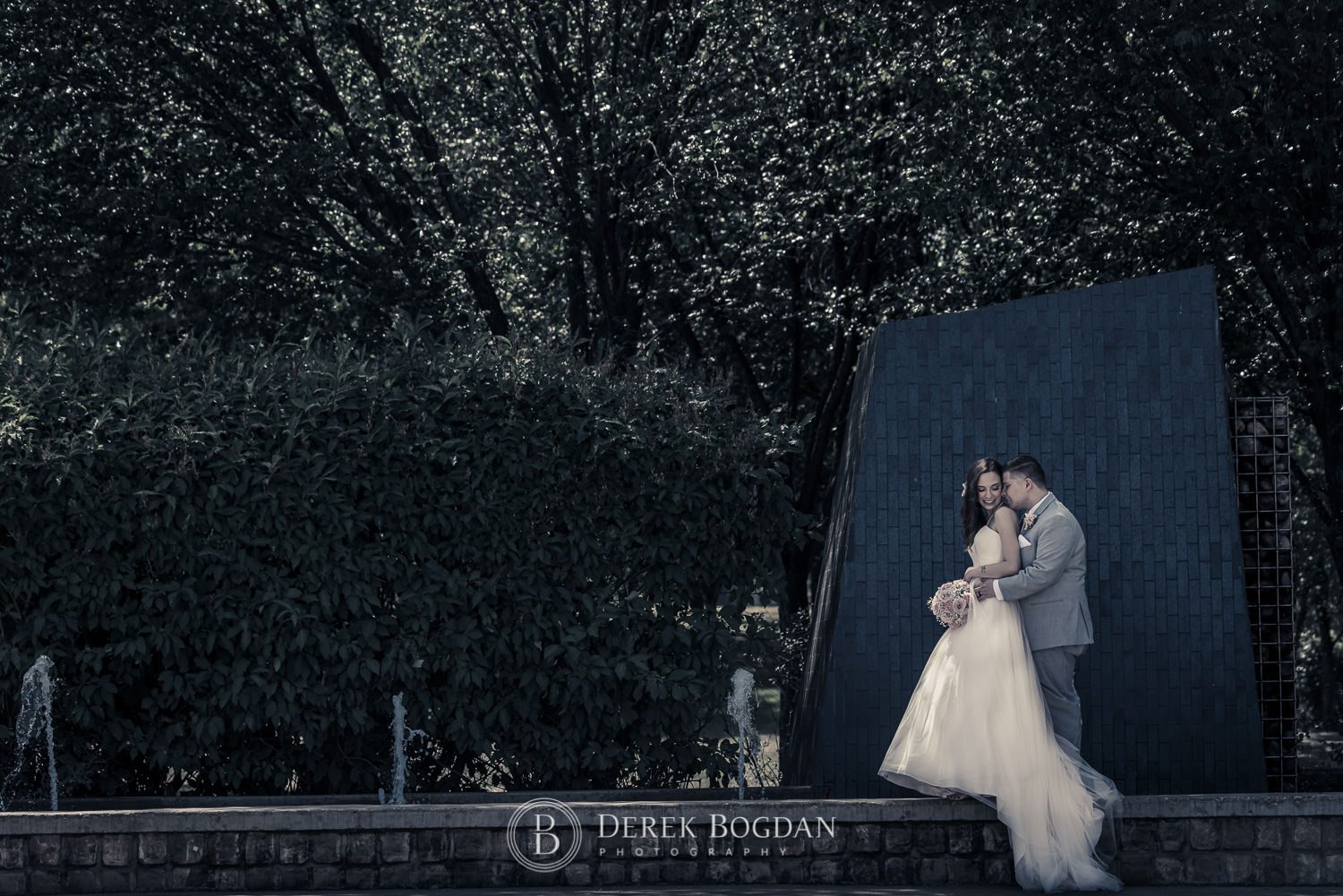 Outdoor wedding at the Forks Bride and groom by fountain