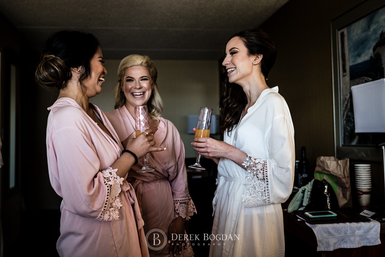 Bride all smiles with bridesmaids getting ready