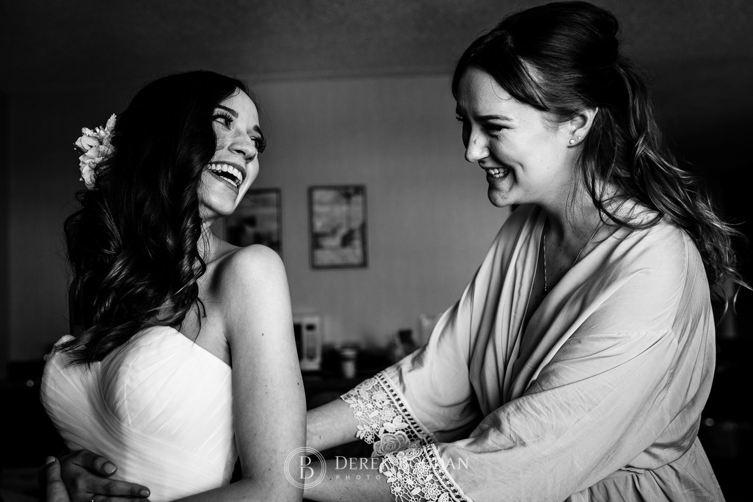 Bride and bridesmaid smiles final dress touch ups