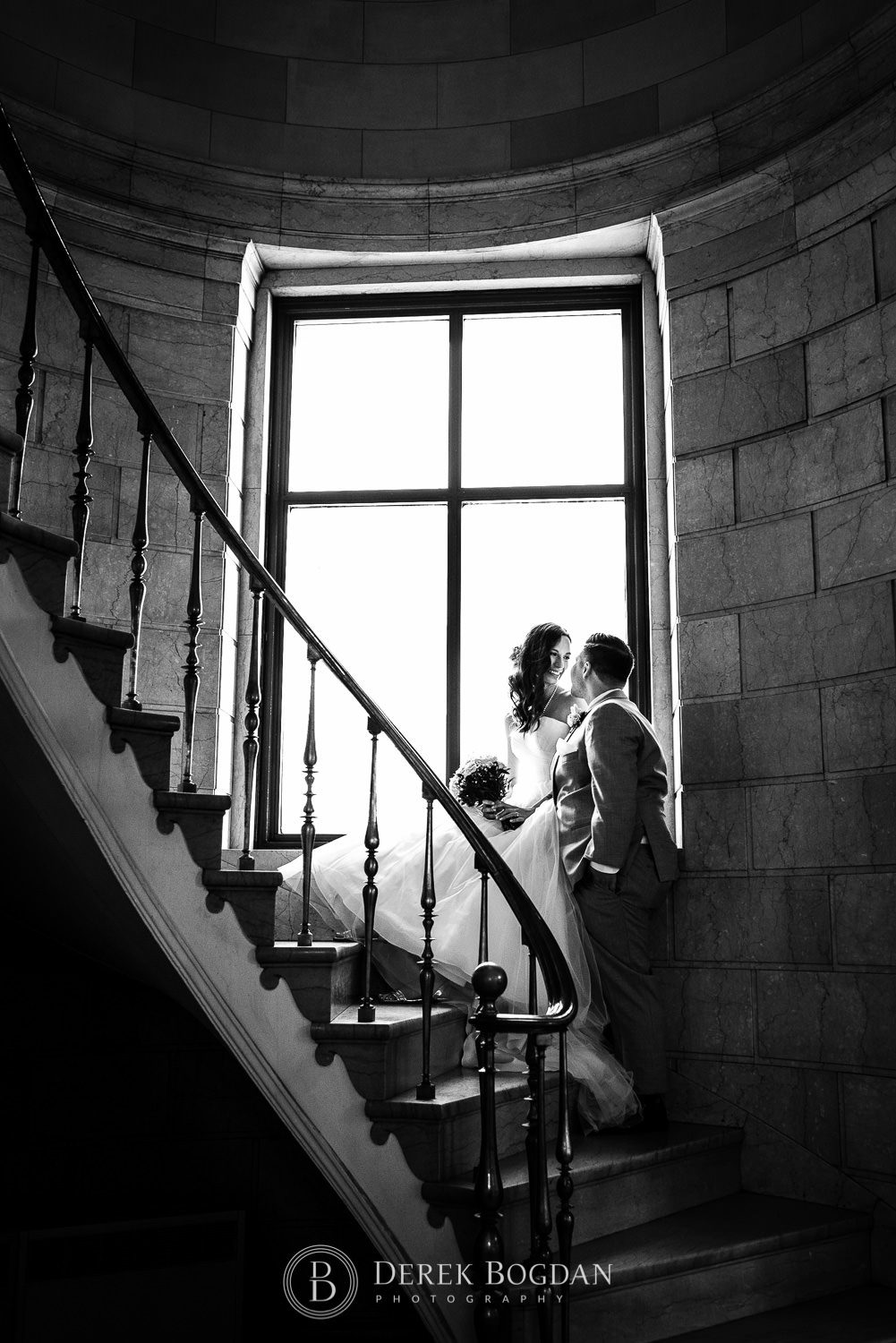 bride and groom portrait on a staircase window