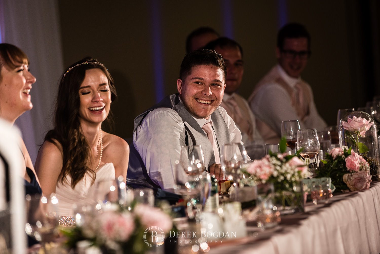 Groom laughing during speeches Victoria Inn Winnipeg wedding reception