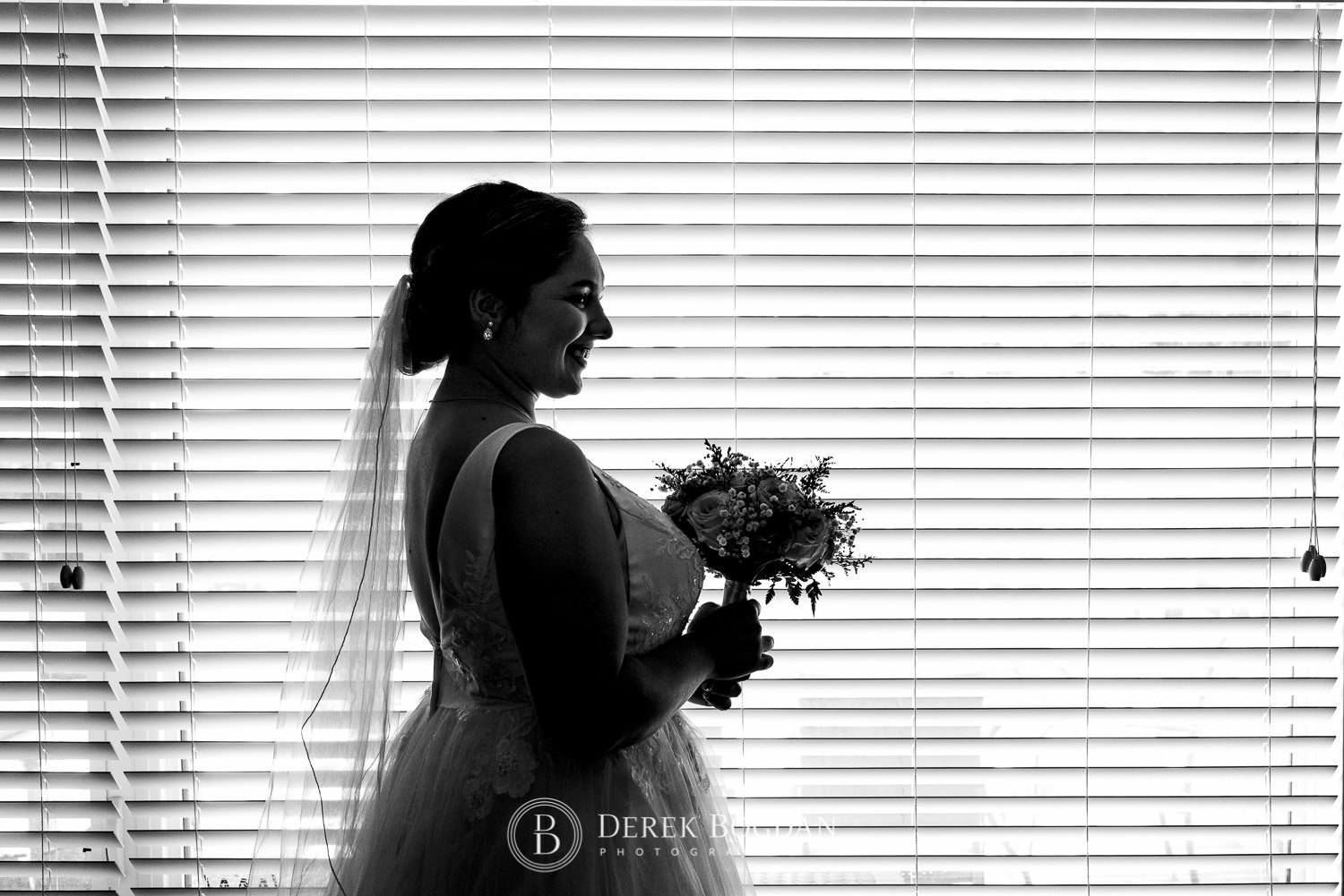 Bride all smiles in front of window