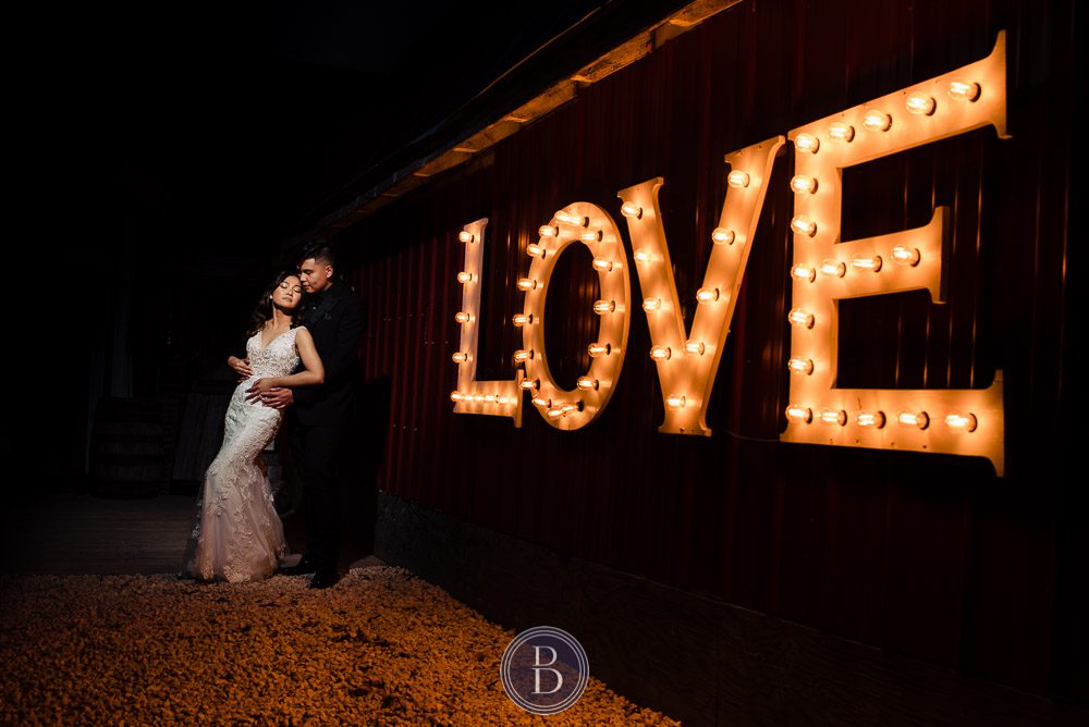 Winnipeg wedding photographer love sign with bride and groom