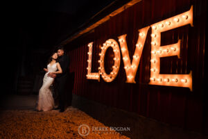 The Rustic wedding Barn love sign portrait newlyweds